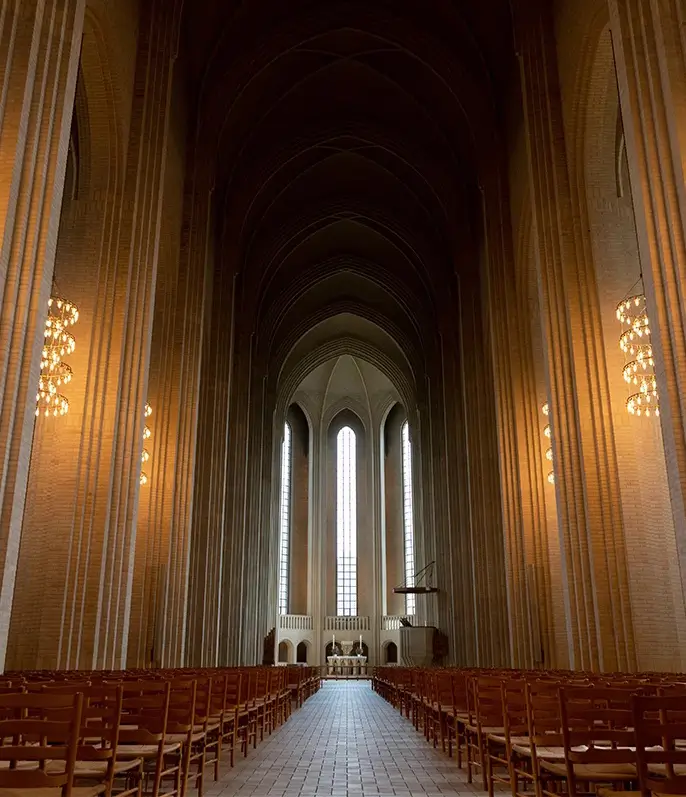 Modern church interior with warm lighting – sacred spaces in need of sustainable use