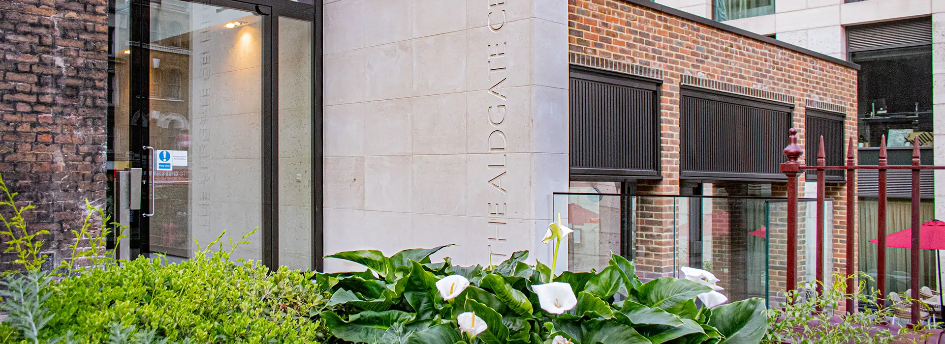 side view ofthe Aldgate Centre – entrance surrounded by planting and heritage detail