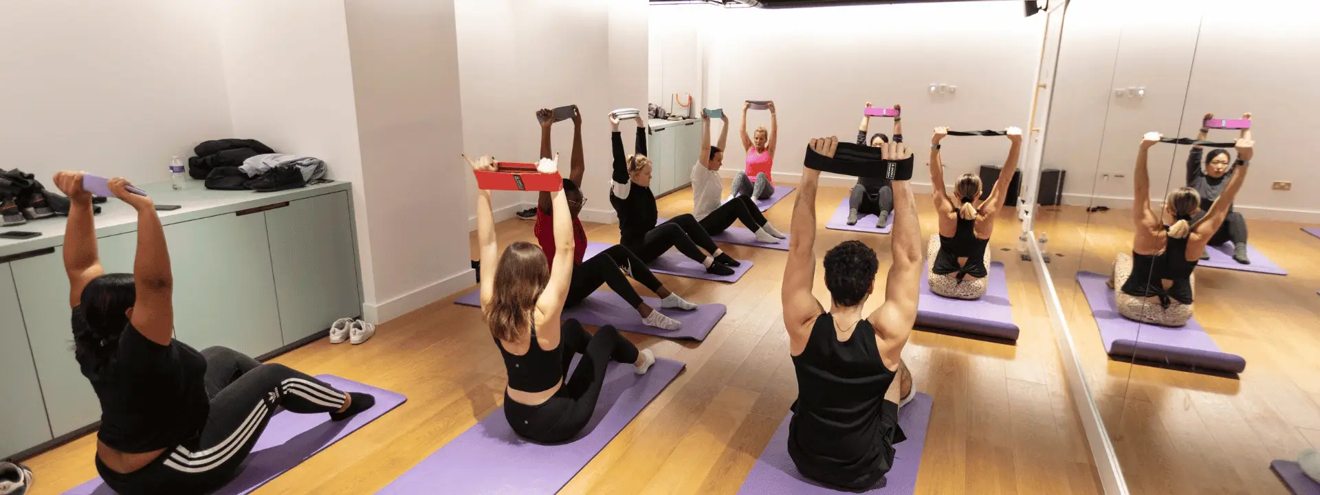 Group exercise class using resistance bands in a hired venue space