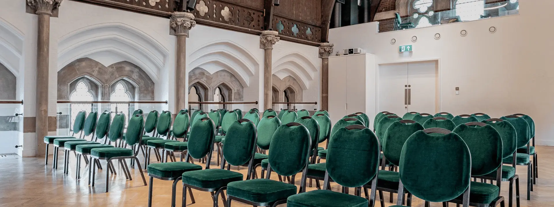 Church venue set up with green chairs for events, illustrating different approaches to church venue hire and commercial use.